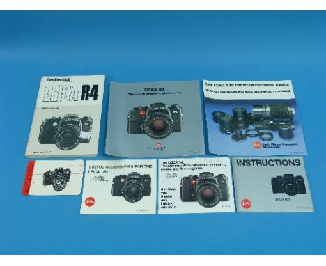 Cameras; a black Leica R4 Camera Body, Leitz Portugal, #1564915, with strap, in makers presentation box with outer sleeve and