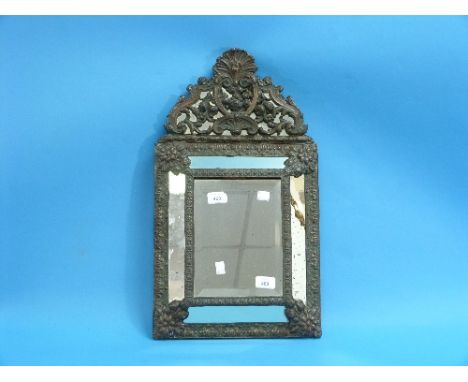 A repoussé copper framed Flemish style Wall Mirror, the central panel with bevel edged glass, mirrored cushion surround, 23½i