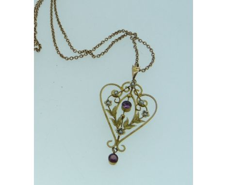 An Art Nouveau amethyst and seed pearl Pendant, of openwork foliate design in yellow metal with a small amethyst drop beneath