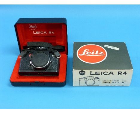 Cameras; a black Leica R4 Camera Body, Leitz Portugal, #1565114, with strap, in makers presentation box with outer sleeve and