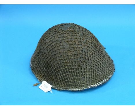A W.W.2 1944 British Army 'Turtle' Helmet, together with a Wehrmacht gas mask tin, a Wehrmacht infantry knapsack with gun cle