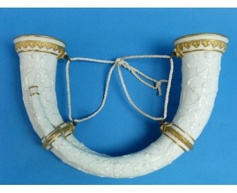 A Royal Worcester white porcelain Wall Vase, modelled as two ornate horns, moulded in relief and decorated in gilt with scrol