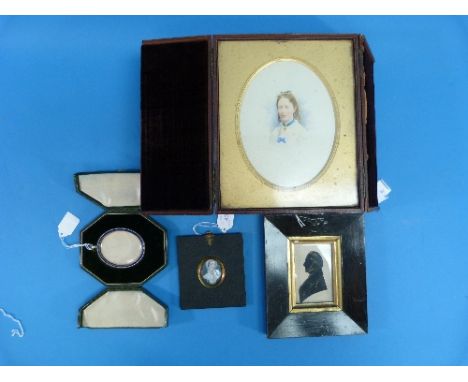 A 19th century silhouette of a Gentleman, framed, and an oval portrait miniature of a woman in gilt-metal mounted papier-mâch
