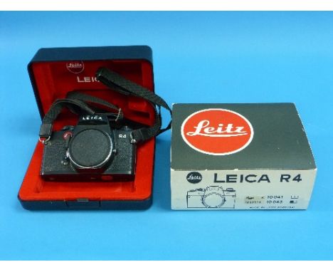 Cameras; a black Leica R4 Camera Body, Leitz Portugal, #1630114, with strap, in makers presentation box with outer sleeve and