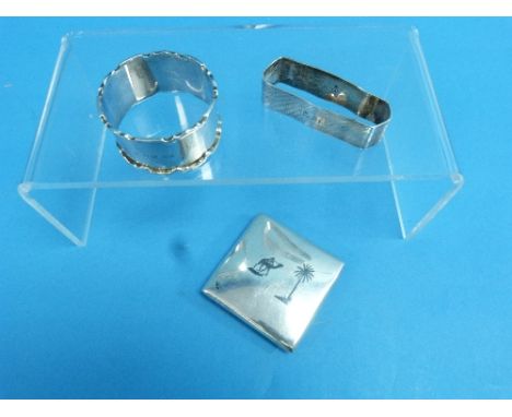 An Eastern silver Powder Compact, of square form with circular hinged mirrored lid, together with two silver napkin rings (3)