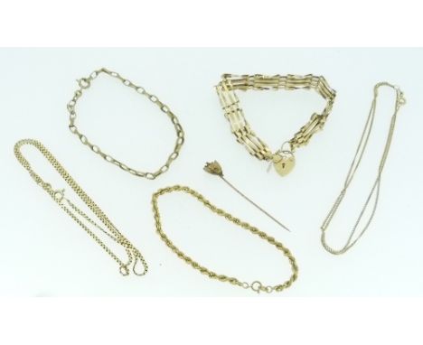 A quantity of 9ct gold, including three bracelets, two trace chains and a stick pin, 19.1g (a lot)