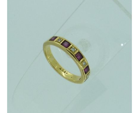 A half hoop Eternity Ring, the front set with five calibre cut rubies with four circular facetted diamonds between, all mount