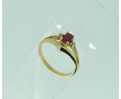 An 18ct yellow gold gypsy set three stone Ring, set in the centre with a diamond with a ruby on either side, Size K, together