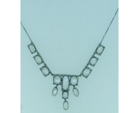 An Arts and Crafts style Moonstone set Necklace, of graduated and drop form, each oval moonstone set in rectangular white met