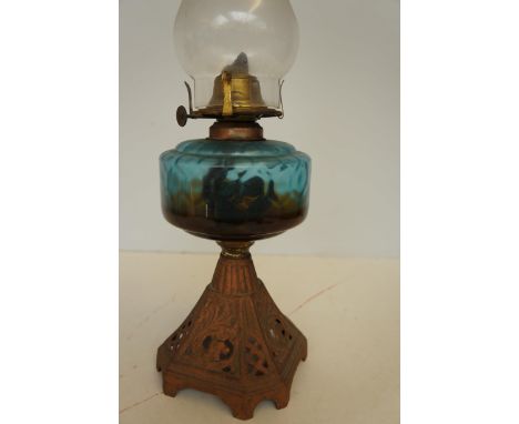 Early cast iron oil lamp with blue reservoir 