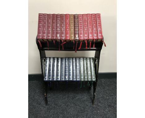 An oak Arts and Crafts two tier book trough containing twenty seven leather bound readers digest books 