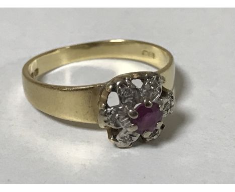 An 18ct gold ruby and diamond cluster ring, size K/L, 2.6g.