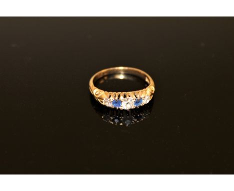 An 18ct gold sapphire and diamond ring CONDITION REPORT: The ring is in good condition. It is size P and weighs 3.6g. The cen