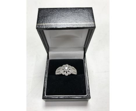 An 18ct white gold diamond encrusted ring, size U. CONDITION REPORT: The ring is in good condition. It is stamped '750' for 1