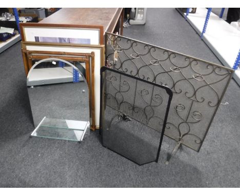 A four piece wrought iron companion set on stand, fire screen tea light holder and a spark guard 