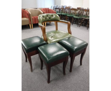 A green button leather armchair and three leather upholstered bar stools  