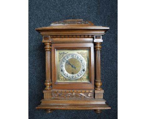 An Edwardian oak bracket clock 