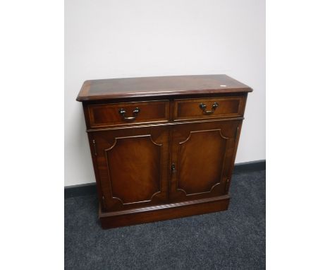 An inlaid mahogany double door cabinet  CONDITION REPORT: 77cm wide by 28cm deep by 77cm high. With one shelf to the interior