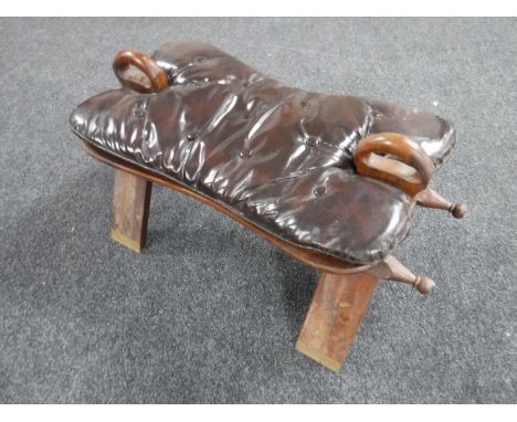 A 20th century camel stool with button leather cushion 