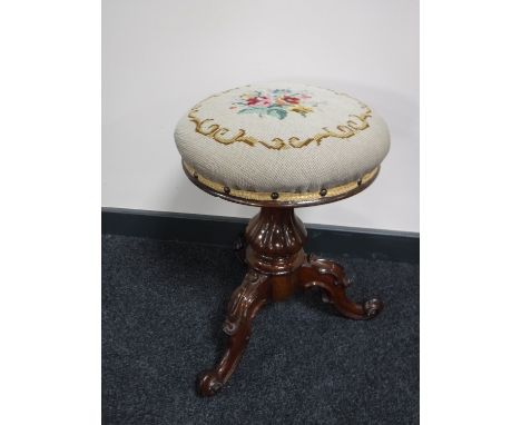 A Victorian mahogany tapestry upholstered tripod stool   CONDITION REPORT: Section missing to carved pedestal base, see image