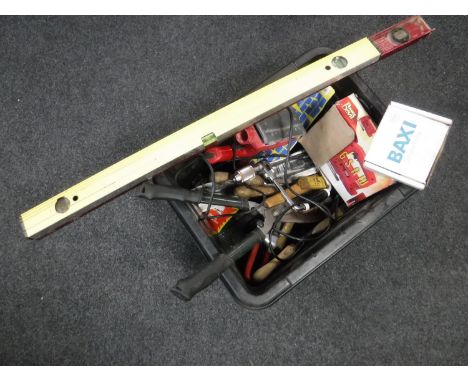 A crate containing a large quantity of assorted hand tools and power tools together with two spirit levels