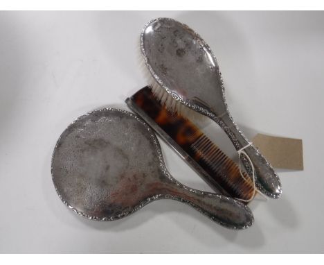 A sterling silver back hand brush, hand mirror and a comb (3). 