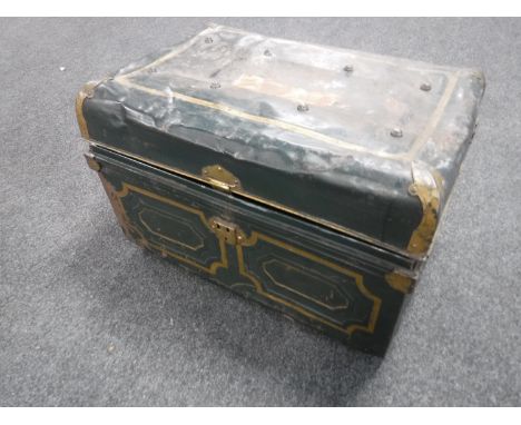 A vintage tin trunk containing cushions