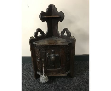 A continental oak corner wall shelf with carved panel door depicting a pheasant 