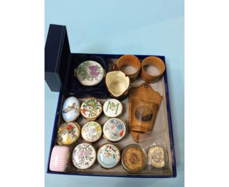 A collection of enamel pill boxes, Mauchline Wares and Doulton etc.