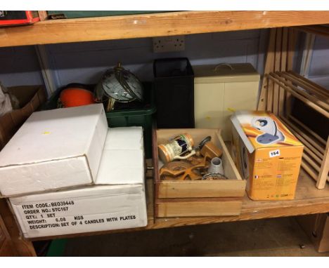 A shelf of homewares including a steam iron, clothes dryer etc.