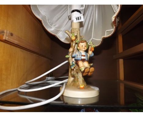 HUMMEL FIGURE OF BEDSIDE LAMP BOY ON A SWING EST [£40- £60]