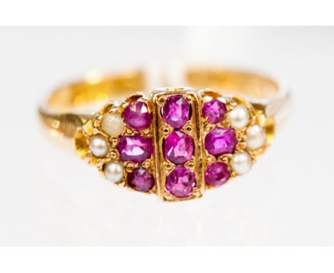 A 15ct  ruby and pearl ring, set with 9 pink rubies in geometric amount and 3 pearls to each shoulder 