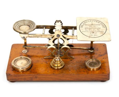 A set of late Victorian postal scales, with Inland letter post price and weight scale stamped to weighing pan, the oak base w