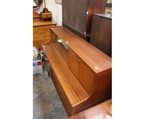 A Nathan teak effect sideboard / cabinet, the top gallery with glazed shelf and fall front cupboard, above a cupboard and thr