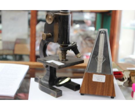 A Spencer Lens Co, Buffalo, NY 34374 microscope and a Wittner metronome 