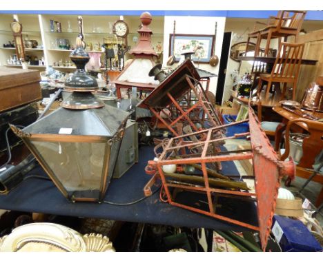 A collection of metal lamps and light fittings, including ships lanterns, modern coaching type and post lamps, etc 