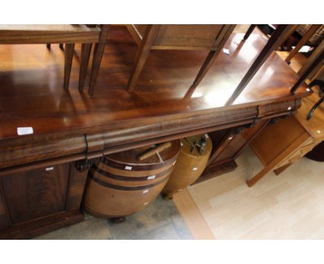 An early Victorian mahogany pedestal sideboard, fitted with three frieze drawers and raised to each side on pedestals, one si