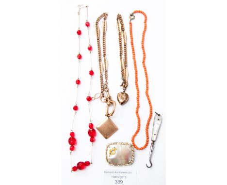 A coral necklace, a gold white and red faceted glass necklace, mother of pearl handled button hook and brooch, along with two