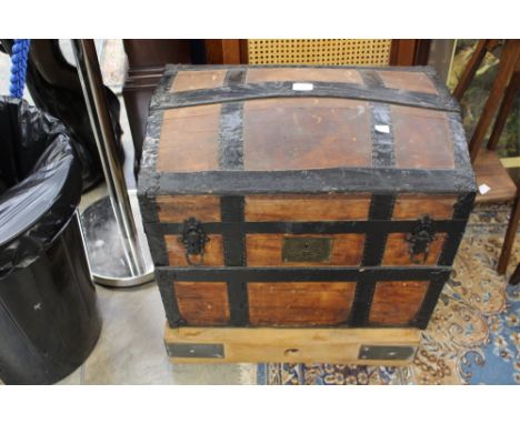 A 20th century butchers block and an early 20th century arch topped travelling trunk, (2)