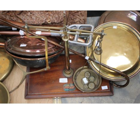 A set of 'Universal' brass balance scales on a mahogany base, with five weights; together with three warming pans, a shooting