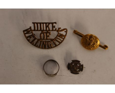 A 'Duke of Wellington's' sew on metal badge, a guards button bar brooch, a George V sixpence ring and a Maltese Cross (silver