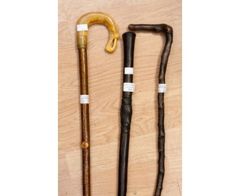 Walking Sticks, an Irish Shillelagh, a Scottish crook with moulded horn and an African mid 20th Century hardwood stick (3) 