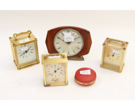 Three reproduction carriage clocks, with quartz movements; together with a 1970s wind up mantle clock, plus a travelling cloc