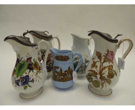 A collection of Prattware jugs with various transfer printed images including Sherborne Abbey and floral specimens, tallest 2