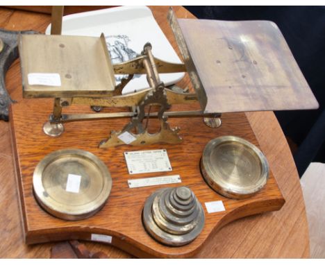 A set of late 19th or early 20th Century postal scales, lacquered brass; together with a set of wall hanging pipe shelves wit