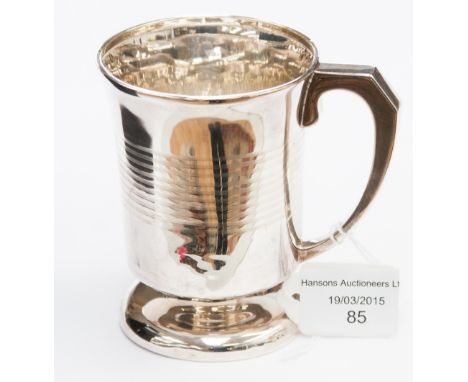 An Art Deco silver mug, footed form with engine turned ring decoration, Birmingham 1931, 2.75 ozt approx
