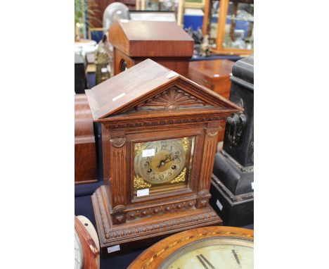 An early 20th Century oak cased mantel clock of architectural form, Westminster chime, gong strike 