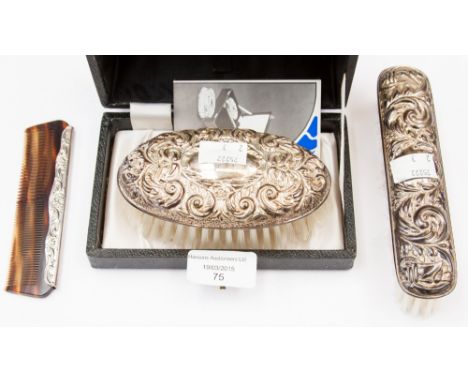 A silver backed three piece brush and comb set in presentation box 