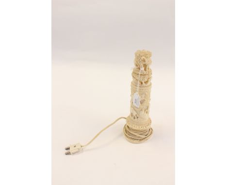 A 1930s carved ivory table lamp, reticulated design with various animals 