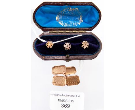 A pair of 9ct gold gentlemen's rectangular cufflinks, engine turned; together with a cased set of three 15ct shirt studs of f